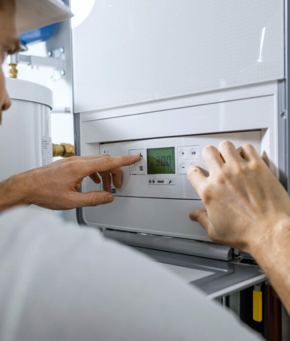 worker set up new central gas heating boiler for home