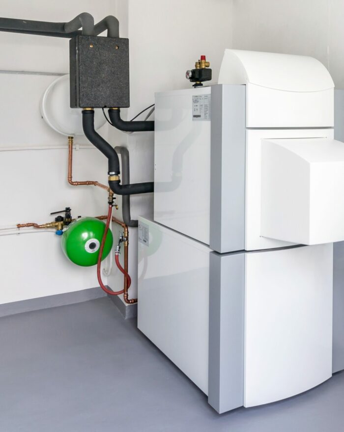 A boiler room with a heating oil warm water system and pipes